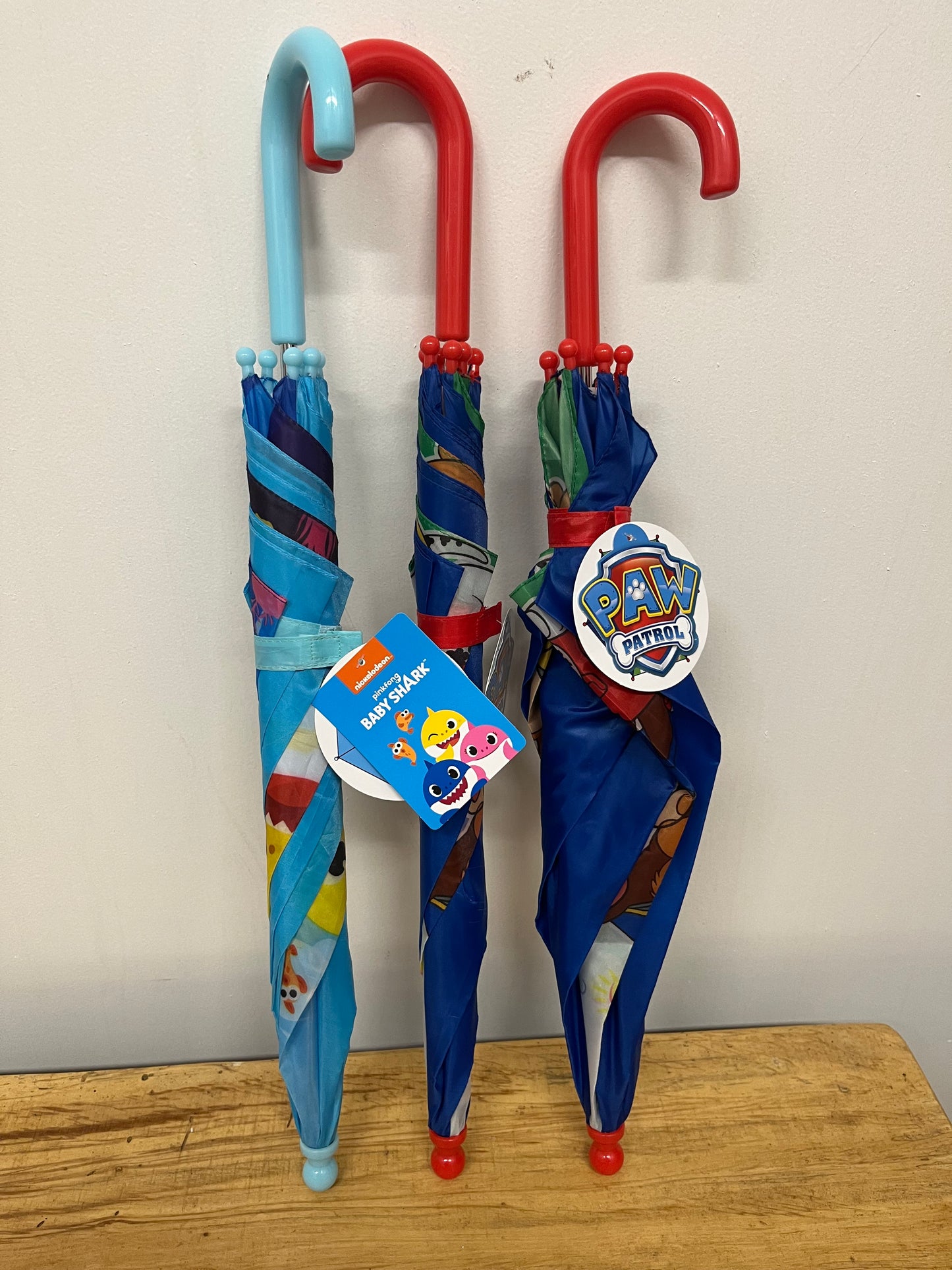 A lot of 3 new 21 inch kids umbrellas 2 paw patrol 1 baby, shark by Nickelodeon